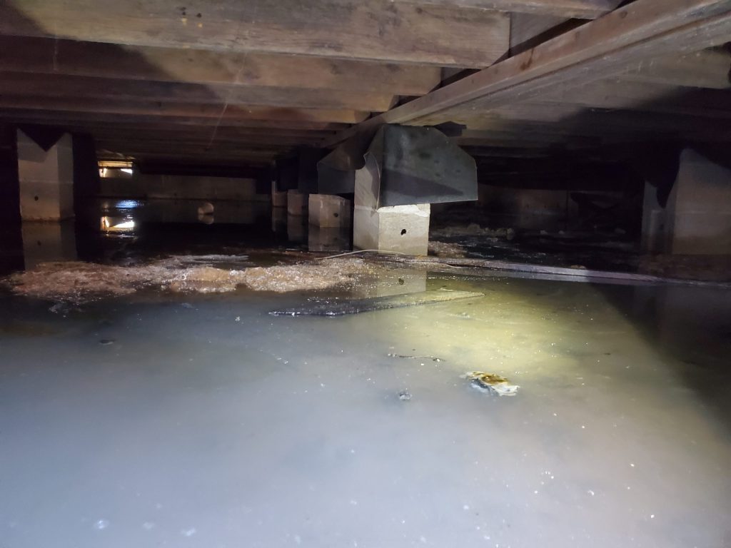 Standing water in a flooded crawl space after a Las Vegas storm