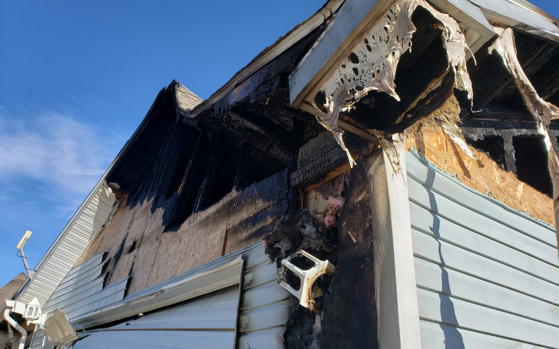 Exterior of a Las Vegas house with fire damage to roof and siding